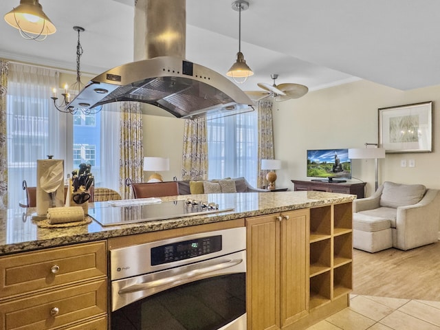 kitchen with black electric cooktop, island exhaust hood, open floor plan, and oven