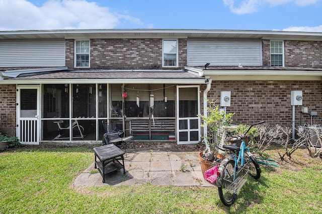 506 Arlington Dr Unit F, Charleston, SC 29414 - rear view of property with a sunroom, brick siding, a patio, and a lawn