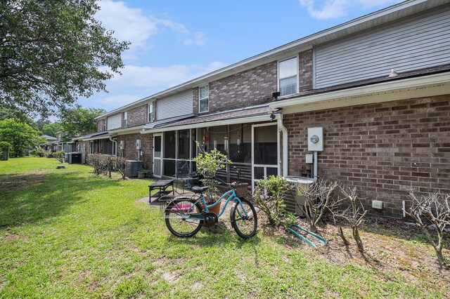 506 Arlington Dr Unit F, Charleston, SC 29414 - back of house with a lawn, a sunroom, brick siding, and central air condition unit