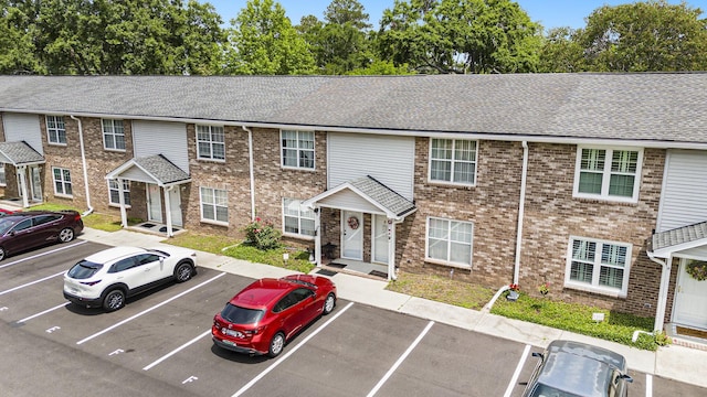 506 Arlington Dr Unit F, Charleston, SC 29414 - view of front of property featuring uncovered parking, a shingled roof, and brick siding
