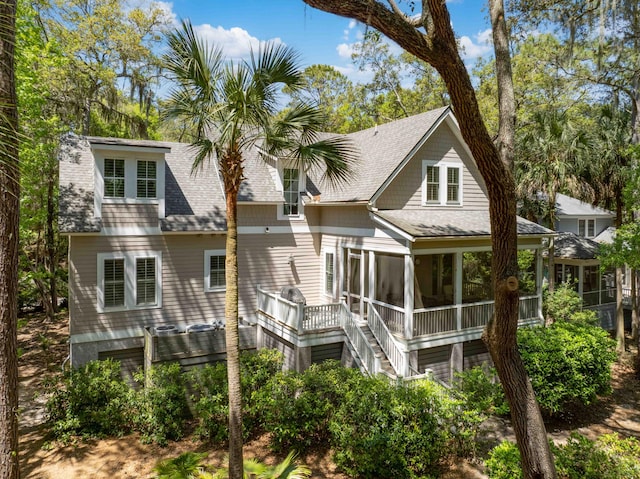 2932 Old Drake Dr, Seabrook Island, SC 29455 - back of property with a sunroom, a shingled roof, and stairs