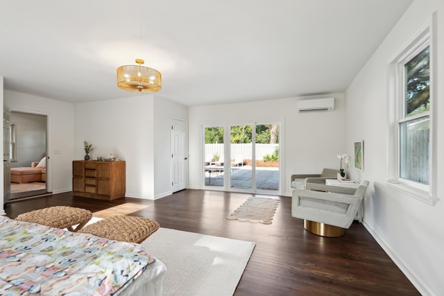 bedroom with dark hardwood / wood-style floors, access to exterior, and an AC wall unit