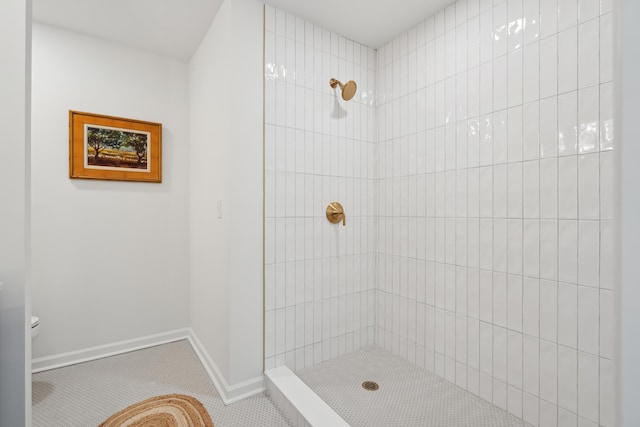 bathroom with a tile shower