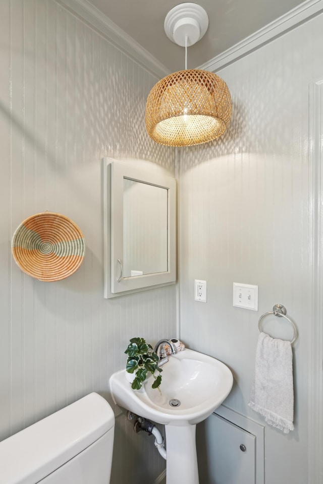 bathroom featuring ornamental molding, sink, and toilet