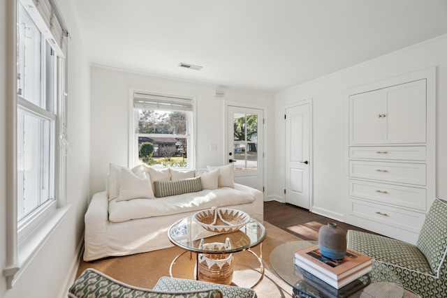 living room featuring crown molding and dark hardwood / wood-style flooring