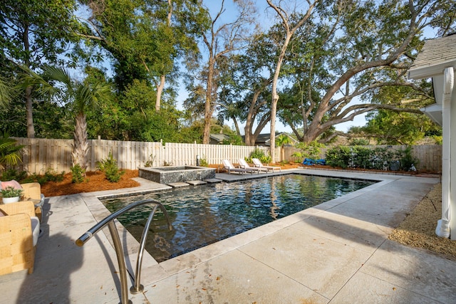 view of pool with an in ground hot tub and a patio