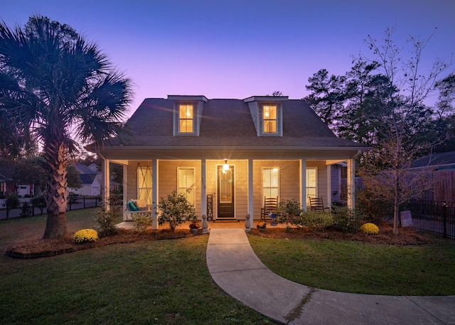 view of front facade featuring a yard and covered porch