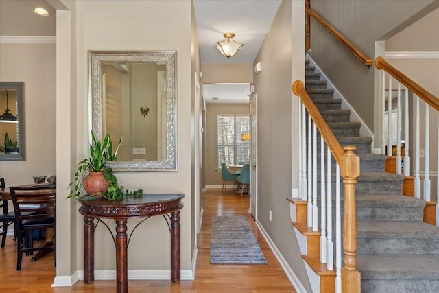 entryway featuring stairs, wood finished floors, and baseboards