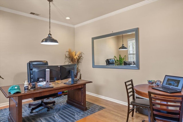 office featuring visible vents, crown molding, baseboards, and wood finished floors