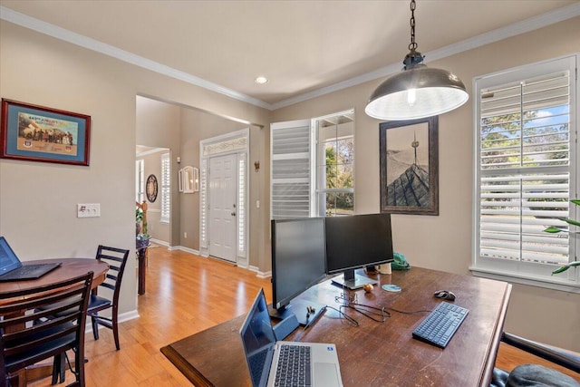 office area with plenty of natural light, crown molding, and light wood finished floors