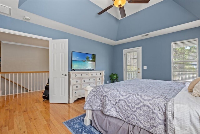 bedroom with visible vents, a raised ceiling, and wood finished floors