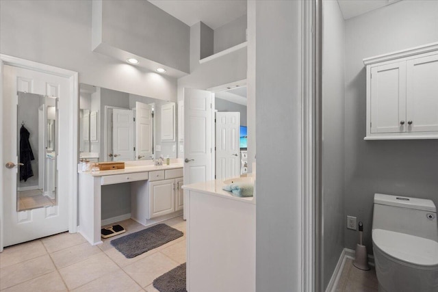 bathroom featuring vanity, tile patterned floors, toilet, and baseboards