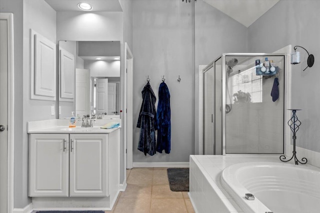 bathroom featuring tile patterned floors, a stall shower, baseboards, a bath, and vanity