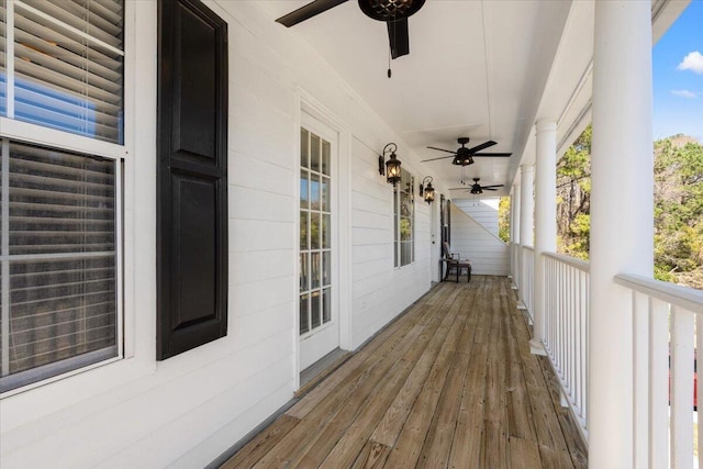 wooden deck with a porch and ceiling fan