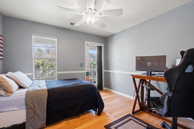 bedroom with ceiling fan, baseboards, light wood-style flooring, and access to exterior