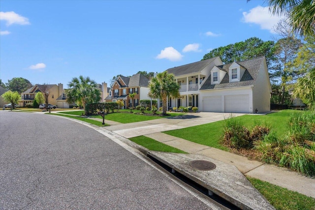 view of front of home with a residential view, a front lawn, a balcony, and driveway