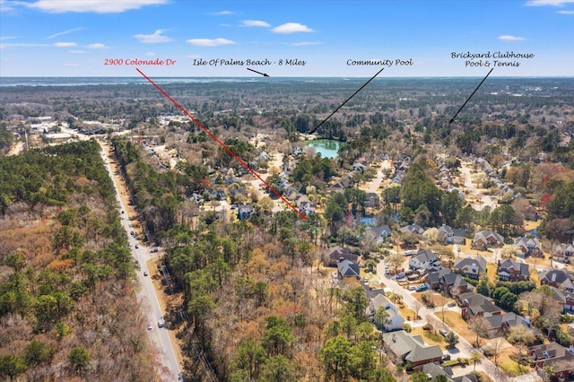 birds eye view of property featuring a wooded view and a water view