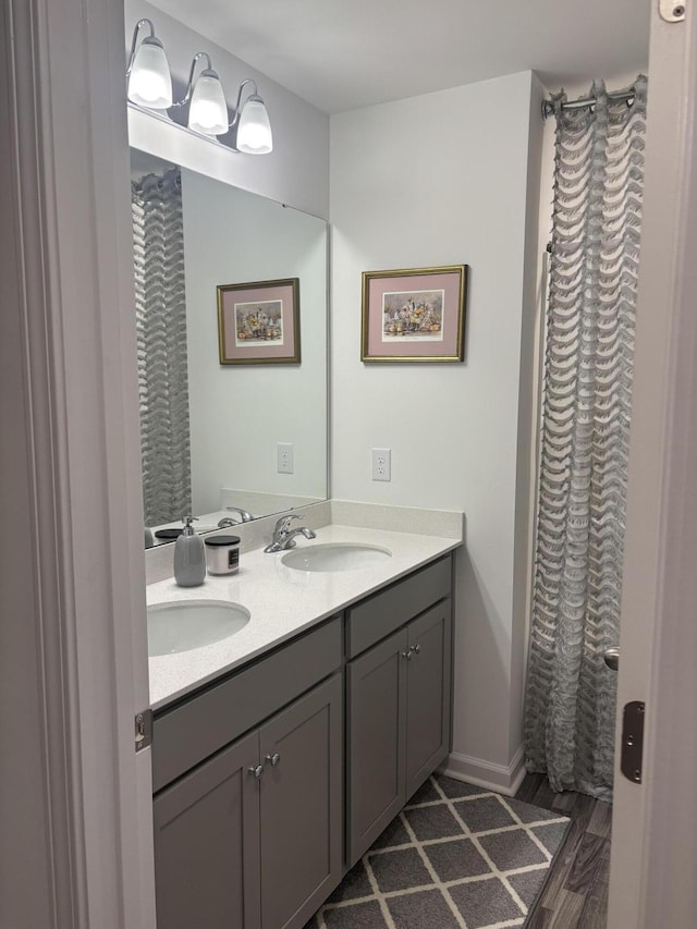 bathroom with vanity and wood-type flooring