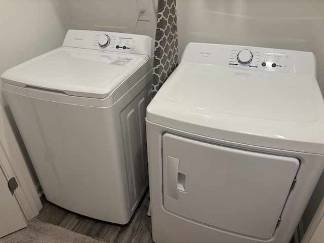 laundry room featuring dark hardwood / wood-style floors and washer and clothes dryer