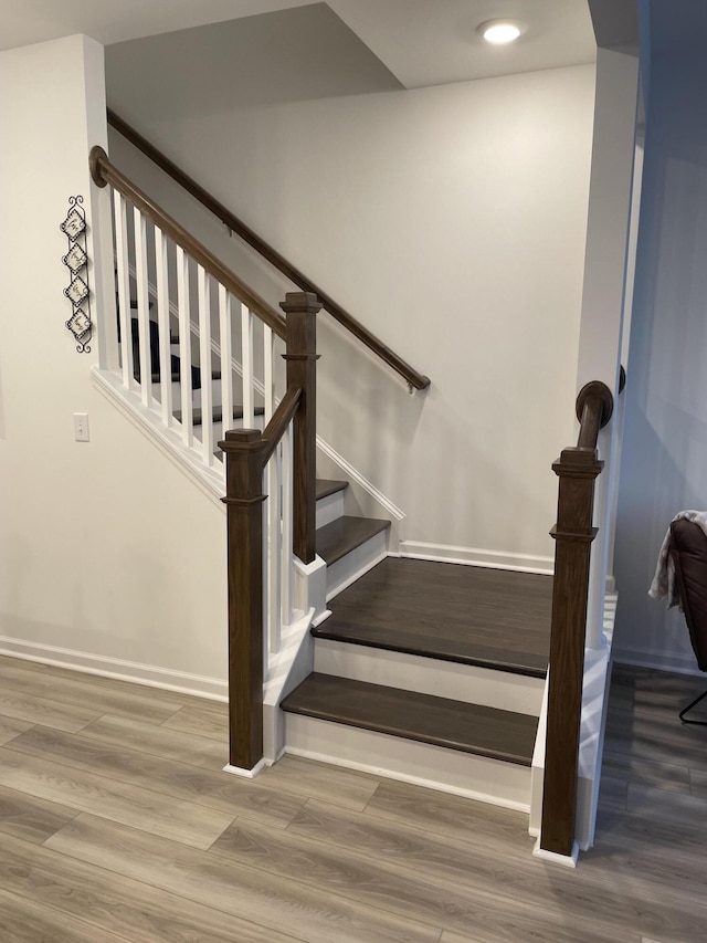 staircase with wood-type flooring