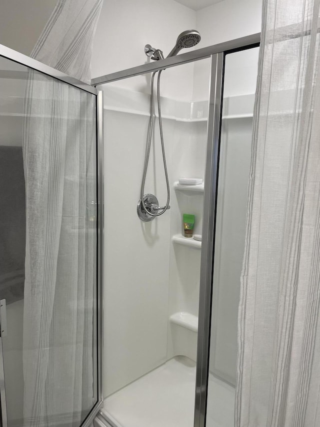 bathroom with a shower with door