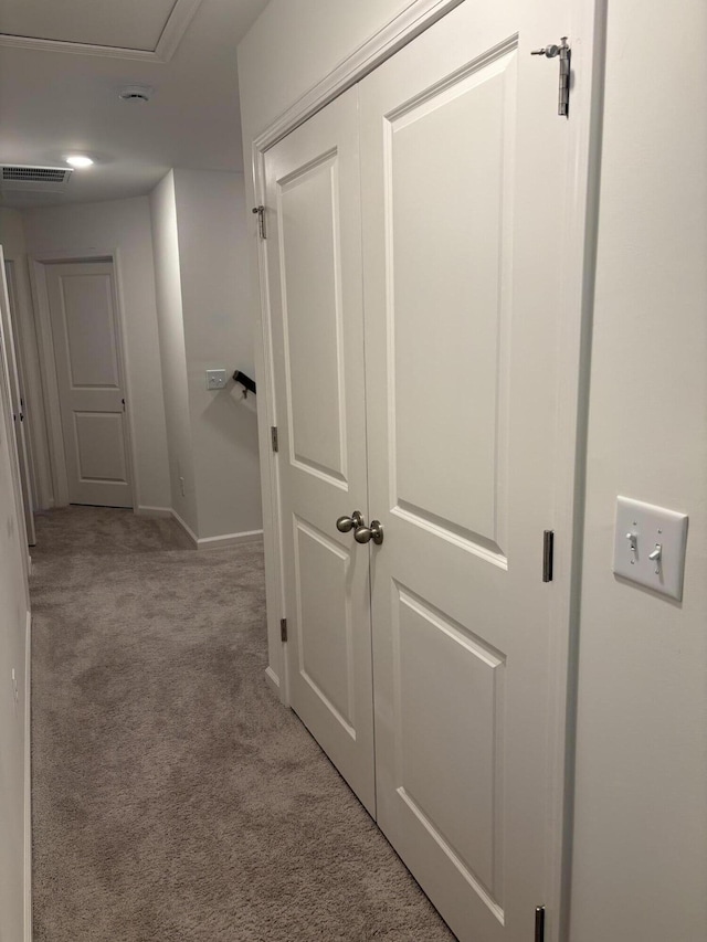 hallway with light colored carpet