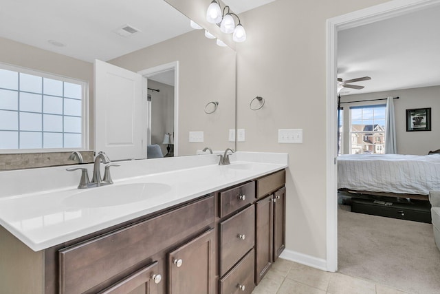 bathroom featuring tile patterned flooring, vanity, and ceiling fan