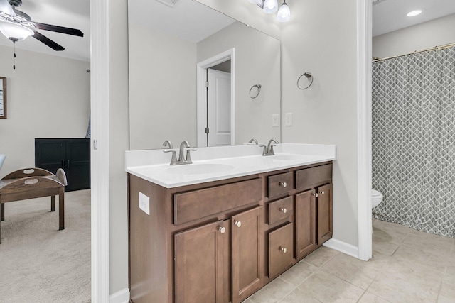 bathroom featuring tile patterned flooring, vanity, toilet, and ceiling fan