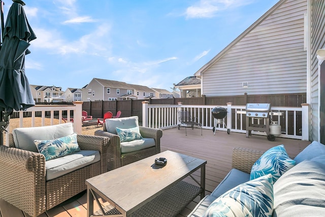 wooden deck with outdoor lounge area and grilling area