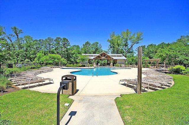 view of pool featuring a patio area and a yard