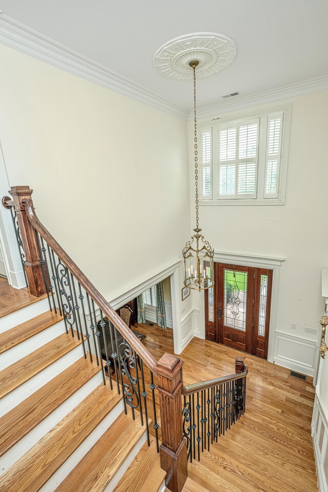 bathroom featuring hardwood / wood-style floors, a bath, vanity, ceiling fan, and crown molding