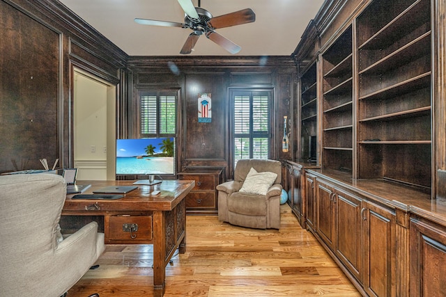 office space featuring crown molding, light wood finished floors, and ceiling fan