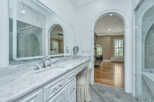 bathroom featuring a shower, crown molding, vanity, and wood finished floors