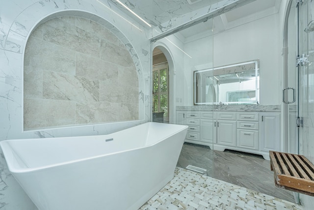 full bathroom featuring a stall shower, marble finish floor, vanity, a freestanding tub, and tile walls