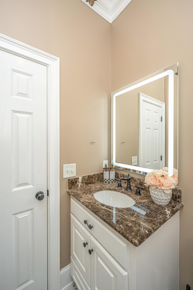 bathroom with vanity and crown molding