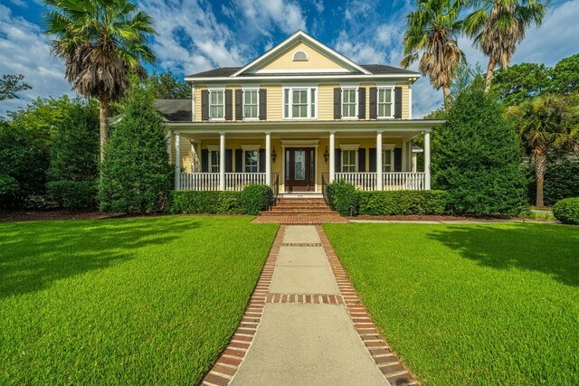 view of front of property featuring covered porch and a front lawn