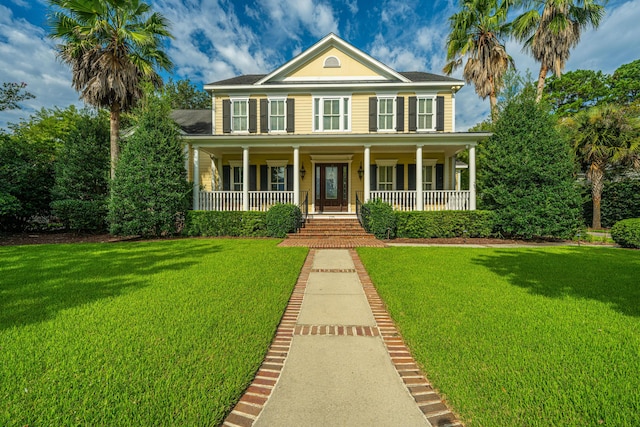 view of front of property with a front yard and covered porch