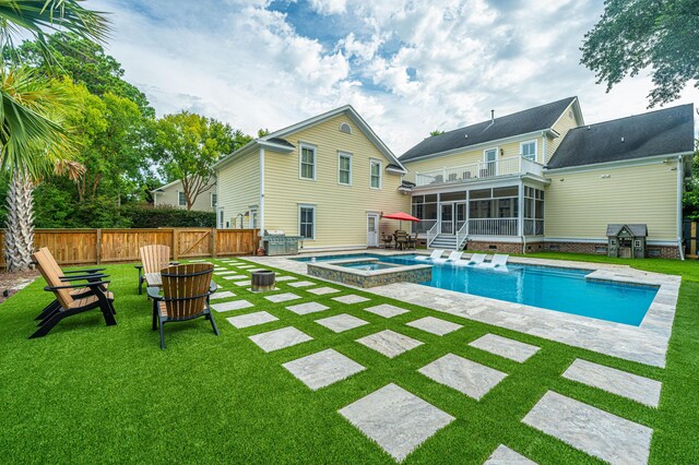 view of swimming pool with an in ground hot tub, a patio area, and a yard