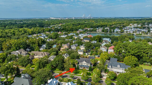 drone / aerial view featuring a residential view and a water view