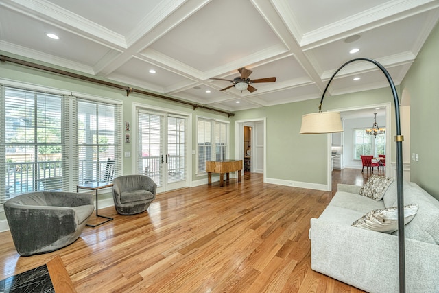 living room with light hardwood / wood-style flooring, plenty of natural light, and coffered ceiling