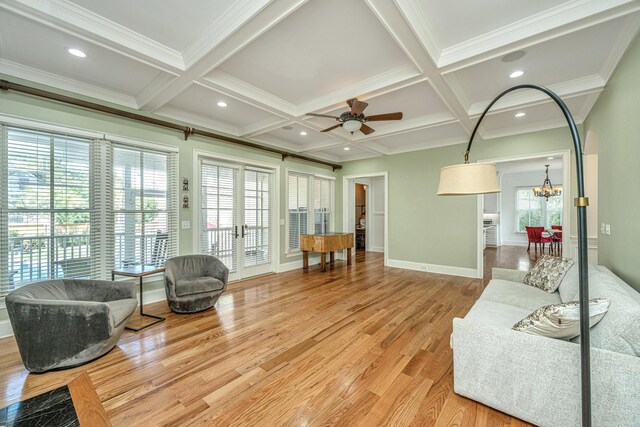 kitchen featuring light wood-type flooring, a kitchen island with sink, tasteful backsplash, stainless steel built in fridge, and white cabinets