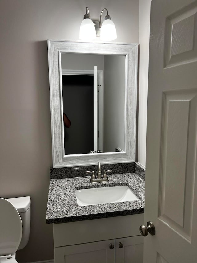 bathroom featuring vanity and toilet