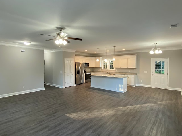 interior space with white cabinetry, a center island, crown molding, pendant lighting, and appliances with stainless steel finishes