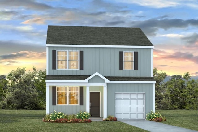 view of front facade with a yard and a garage