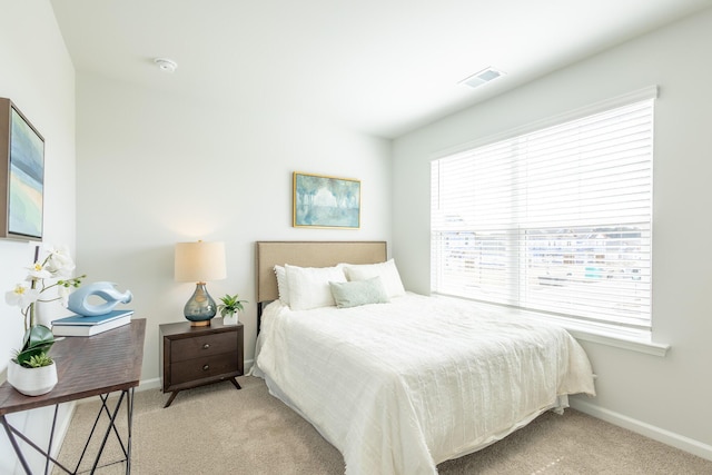 carpeted bedroom featuring multiple windows