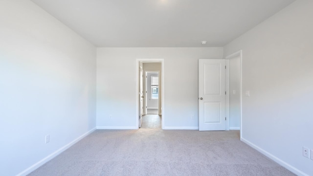 spare room with light colored carpet