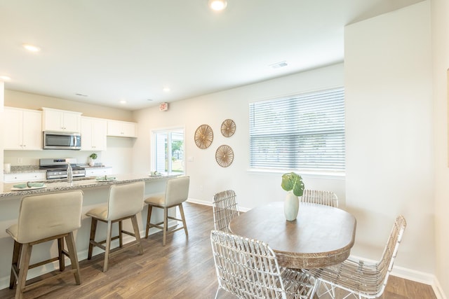 dining room with dark wood-type flooring