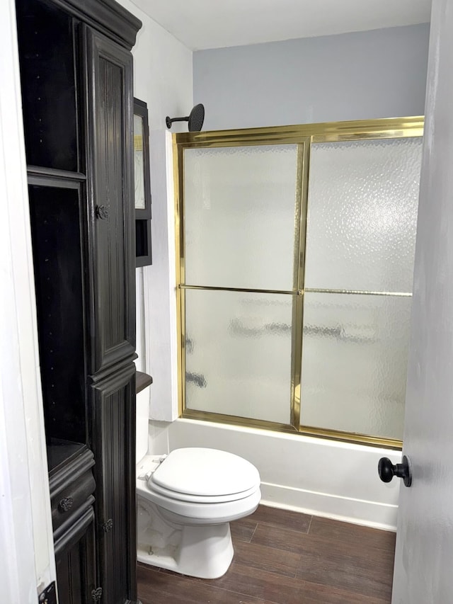 full bathroom featuring enclosed tub / shower combo, wood finished floors, and toilet