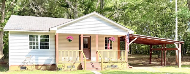 view of front of home with a carport, a shingled roof, a porch, and crawl space