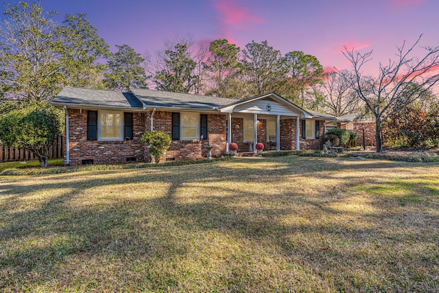 ranch-style house with a yard and a porch